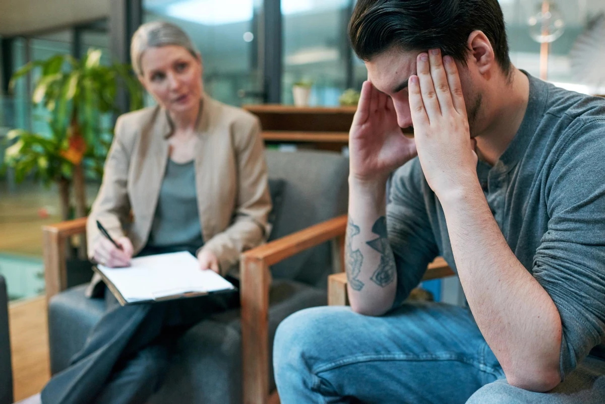 Counseling session in a modern setting, with one person visibly distressed and another offering professional support—symbolizing care, reflection, and mental health guidance.